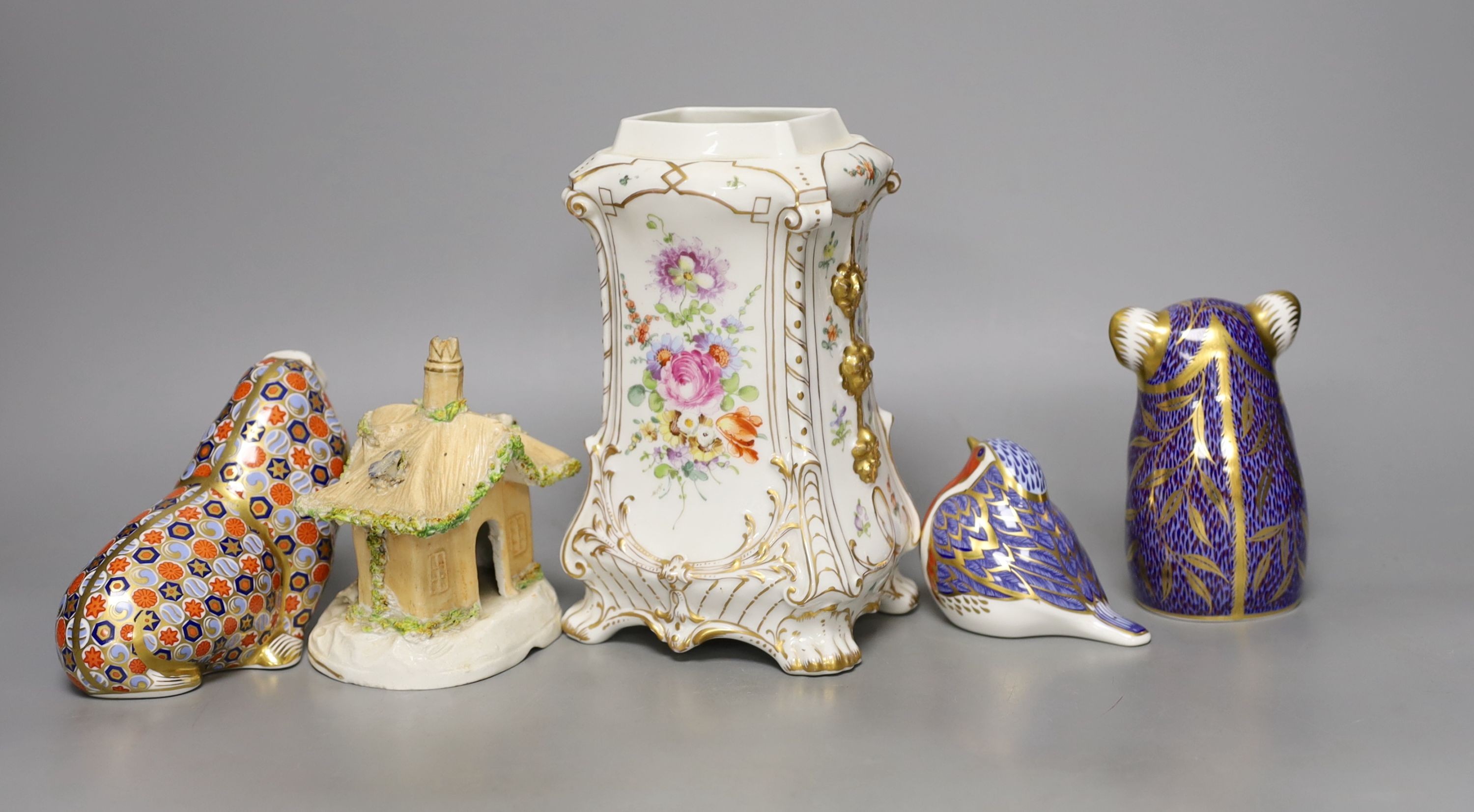 Three Crown Derby animal paperweights, a pastel burner cottage and a Continental gilt and floral decorated vase, tallest item vase 19 cms high.